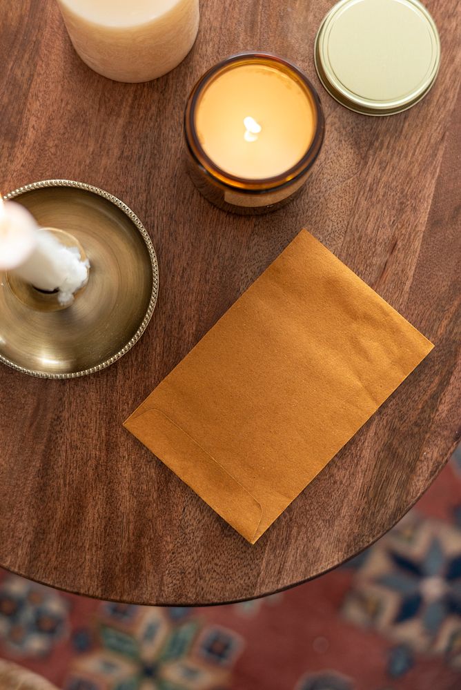 Flay lay envelope with candles on wooden table