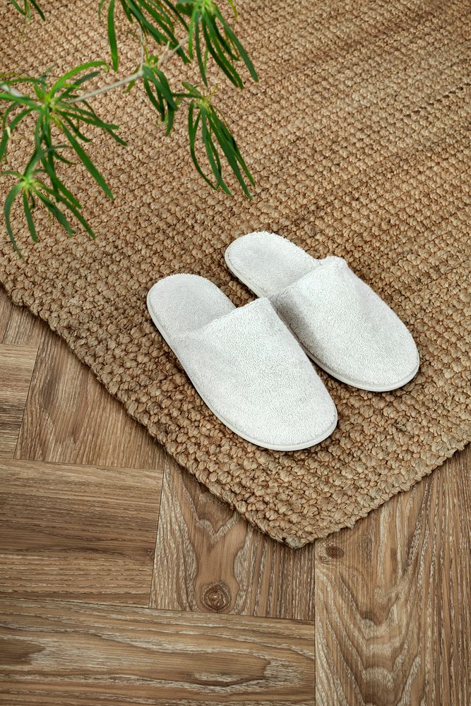 White indoor slippers on jute rug