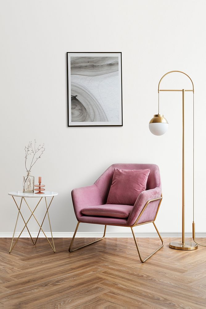 Picture frame with abstract art by a pink velvet armchair
