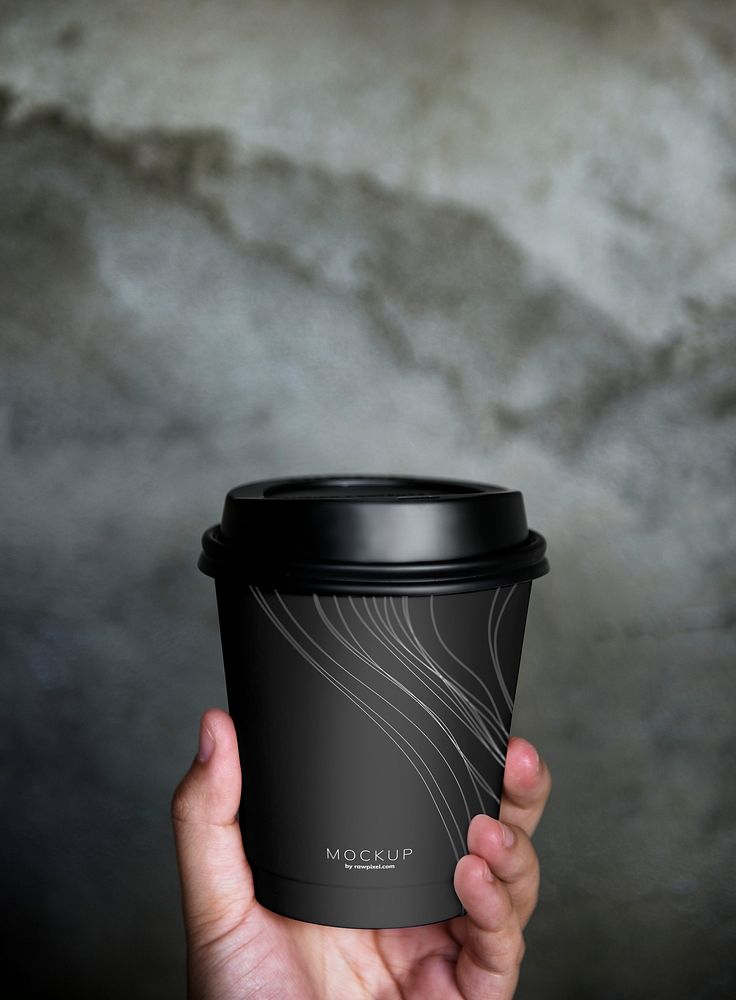 Human hand holding a mockup coffee cup