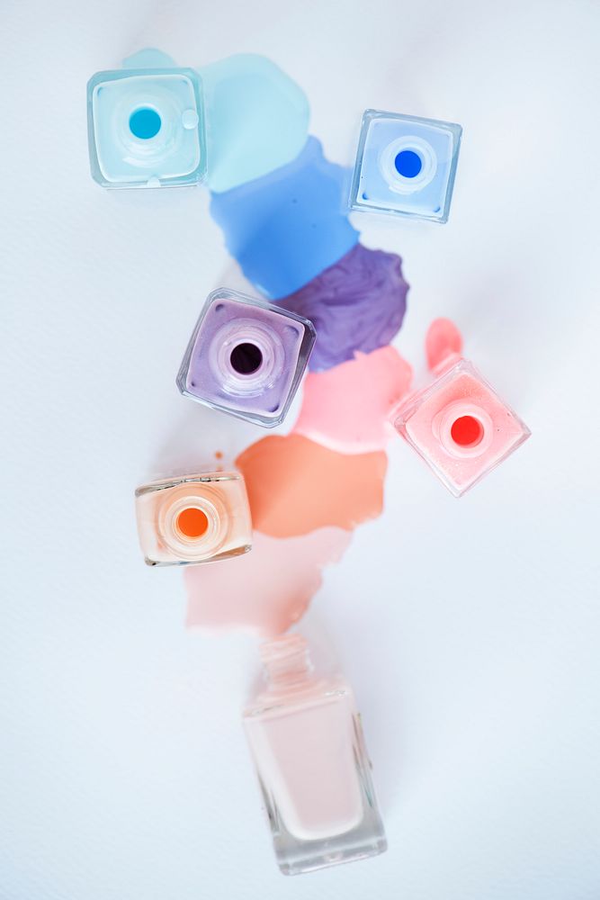 Flat lay of pastel nail polish bottles