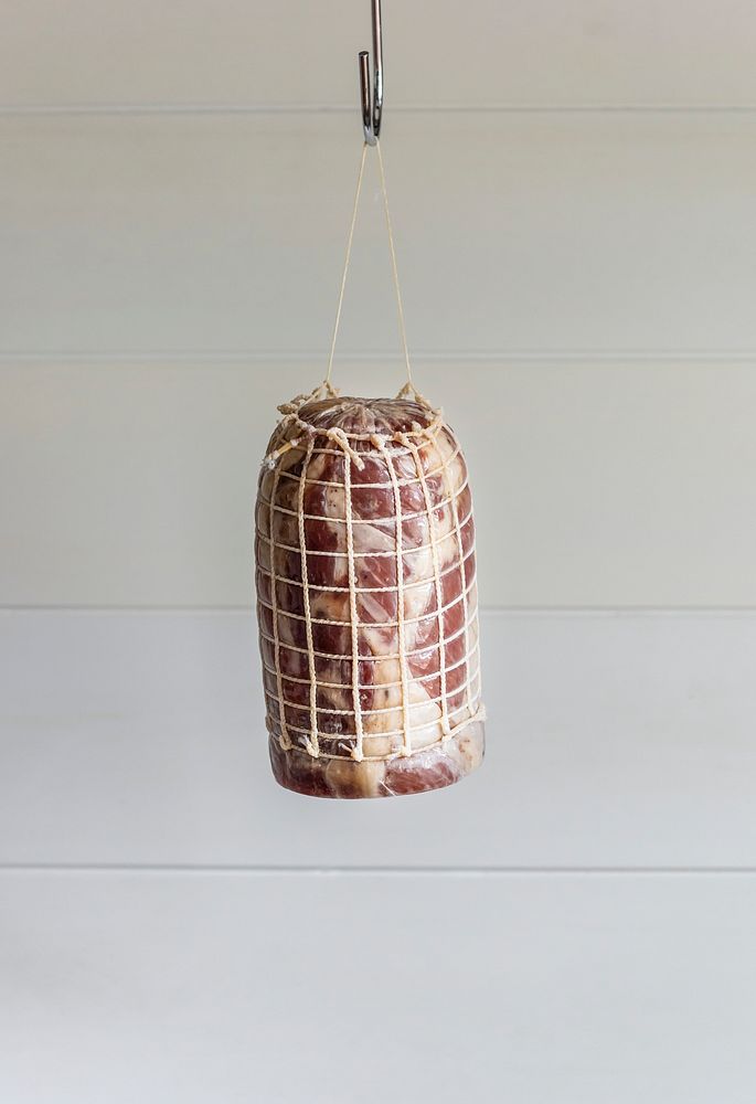 Dry aged meat hanging in a kitchen