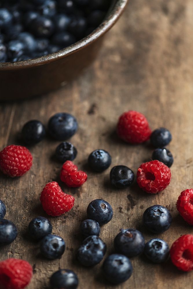 Fresh strawberries and blueberries on a wooden table