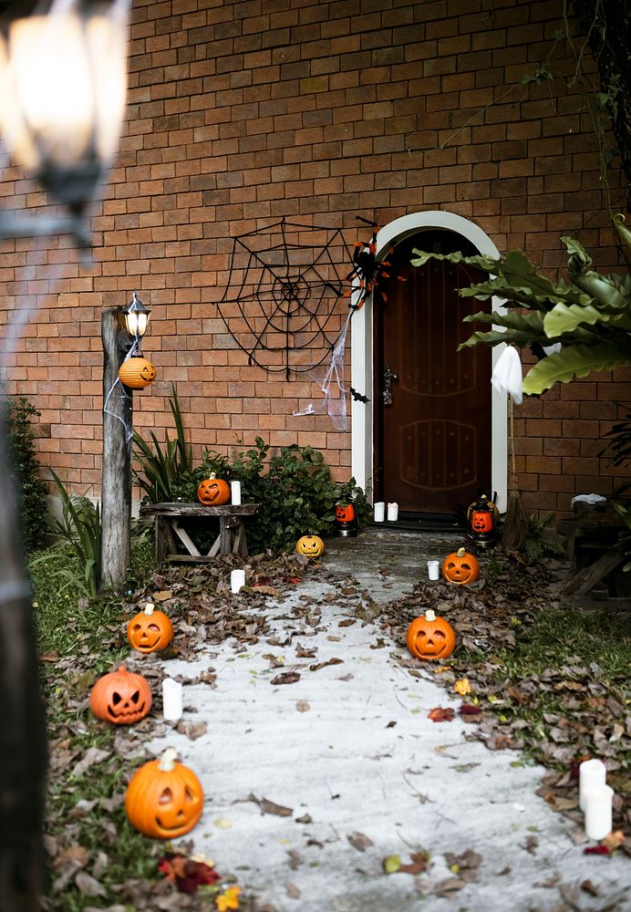 Halloween pumpkins and decorations outside a house