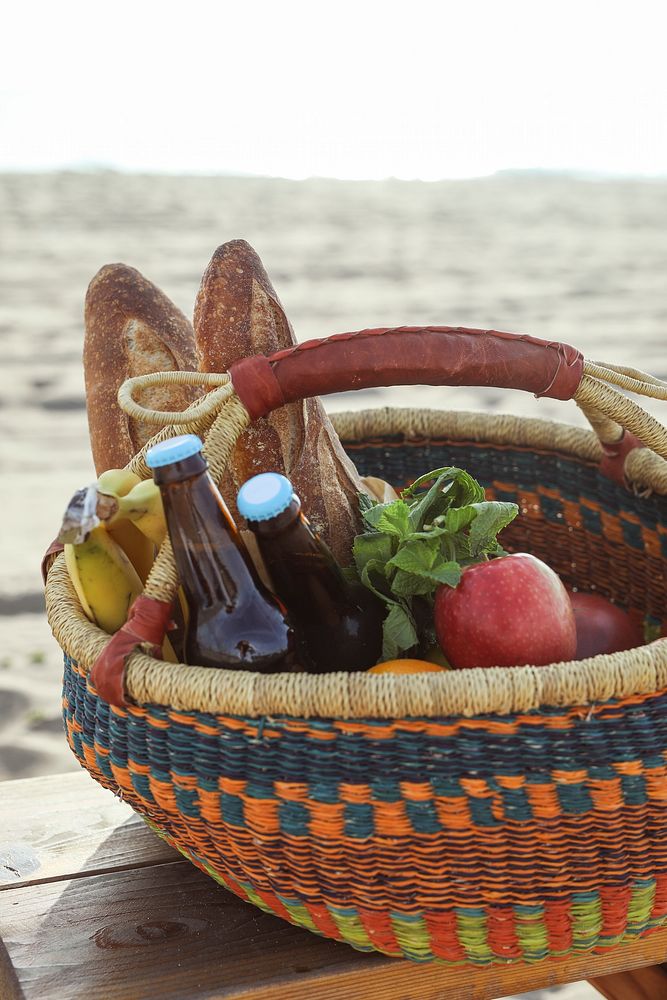 Picnic basket filled with snacks and drinks at the beach