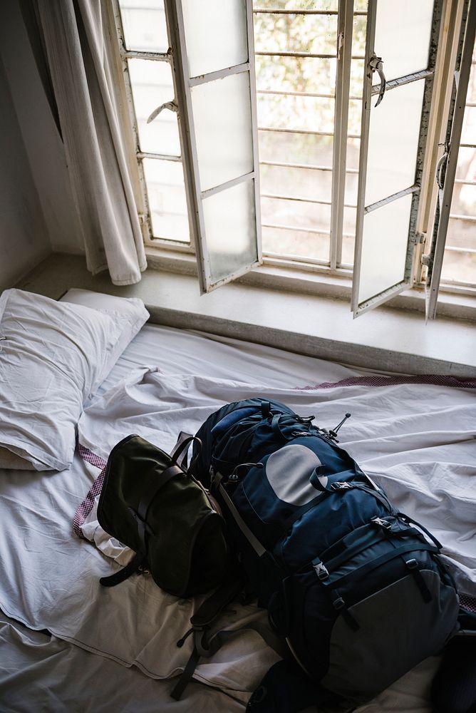 Backpack on a bed in a hotel room in the morning