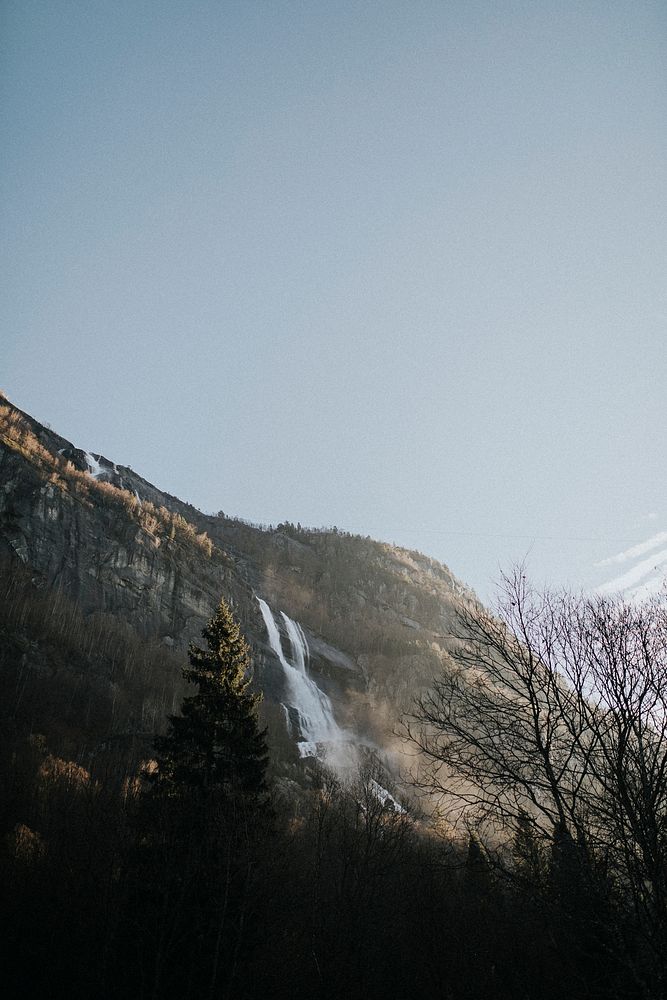 View of a waterfall and a mountain in Norway