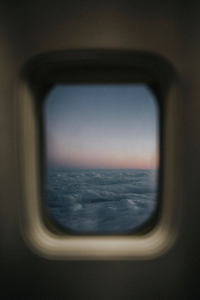 View of a cloudy sky from a plane window