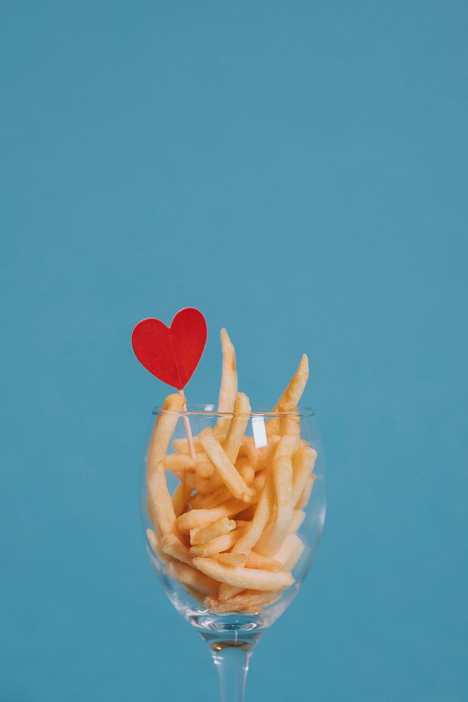 French fries in a wine glass with a heart ornament