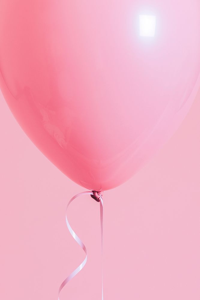 Single pastel pink balloon with a string
