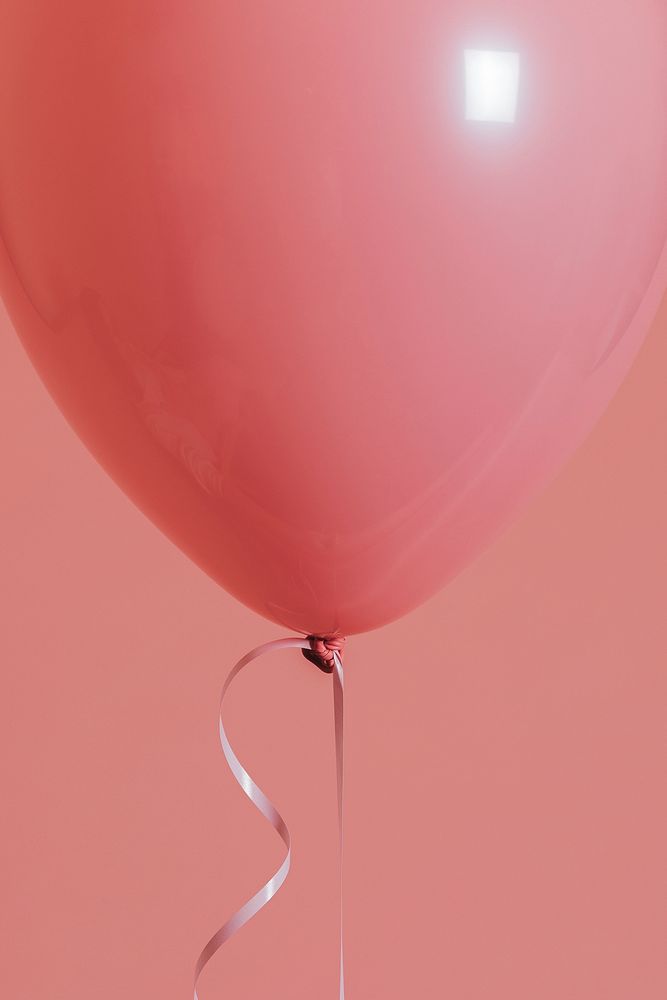 Single pastel pink balloon with a string