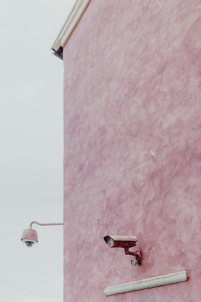 Pink wall with a CCTV