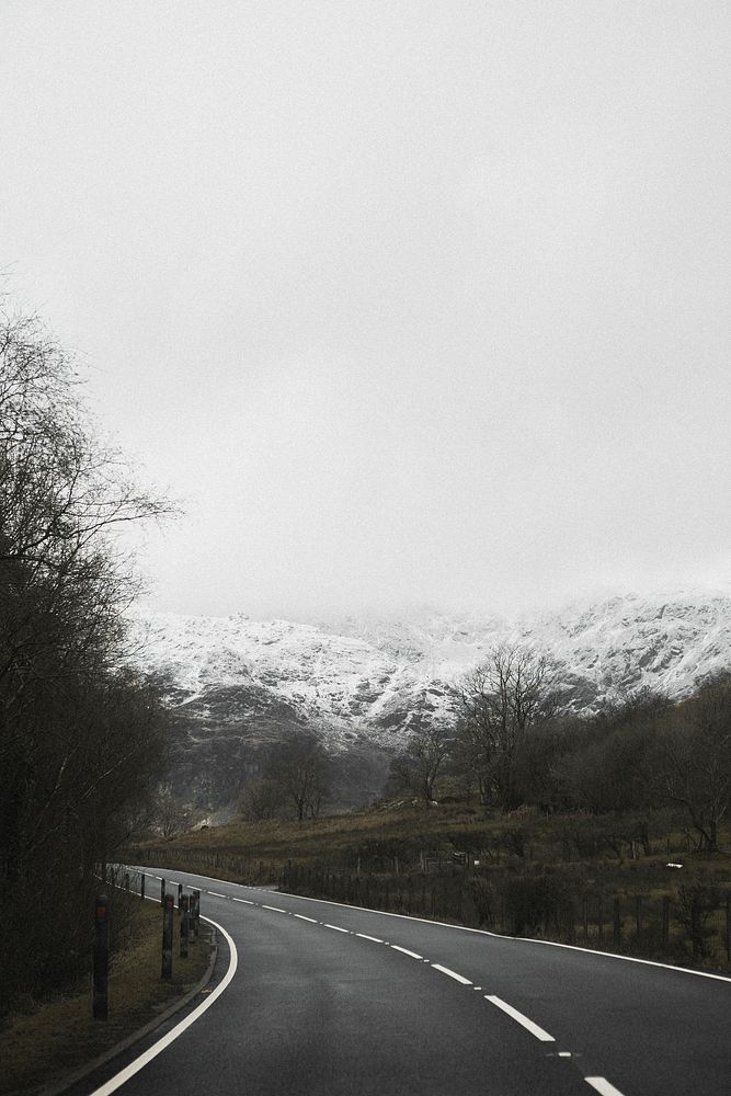 View of a road leading to snowy mountains
