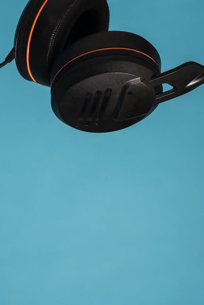 Black headphones isolated on blue background