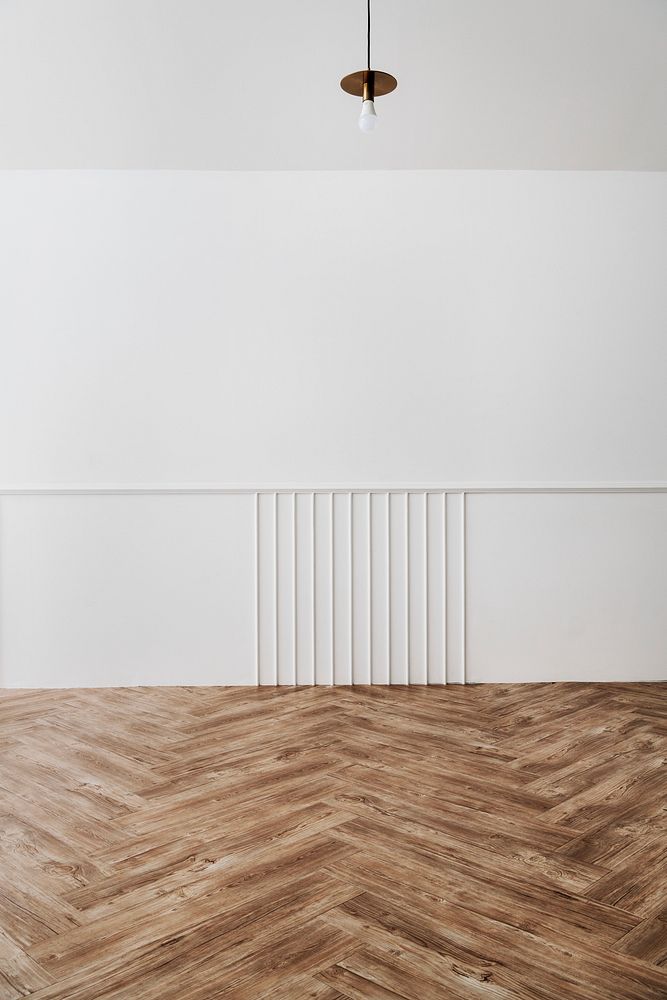 A room with a white wall and parquet
