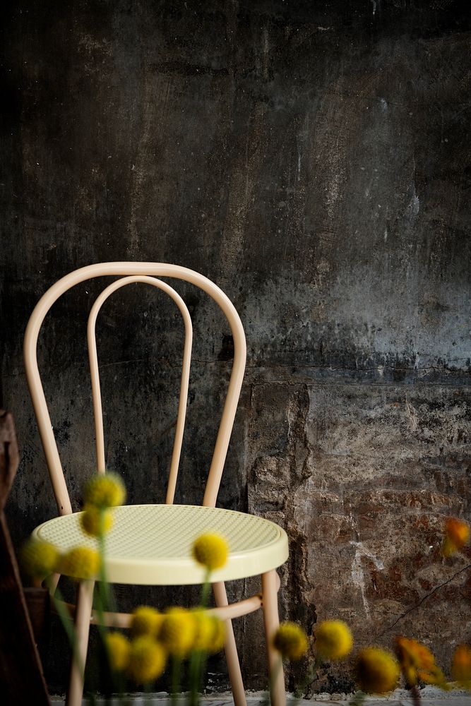 Vintage chair by a cement wall