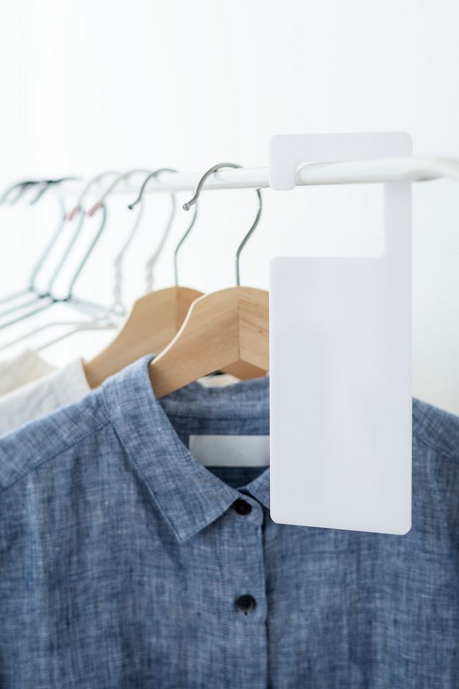 Shirt on a clothing rack with a tag mockup in a studio
