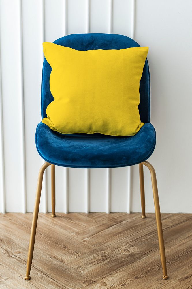 Yellow cushion on a blue velvet chair