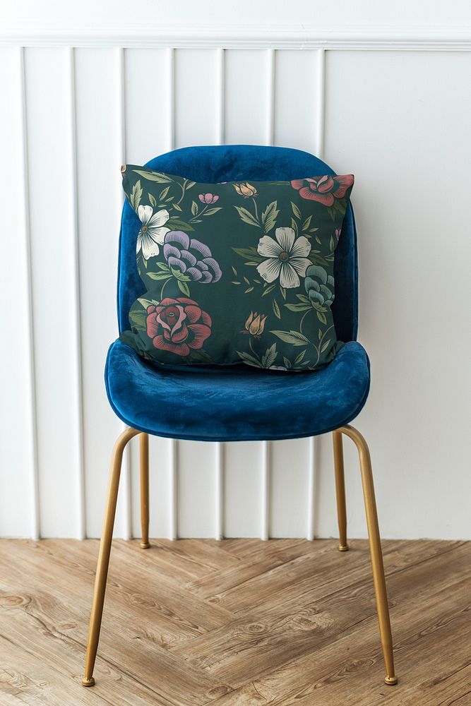 Botanical pattern cushion on a blue velvet chair