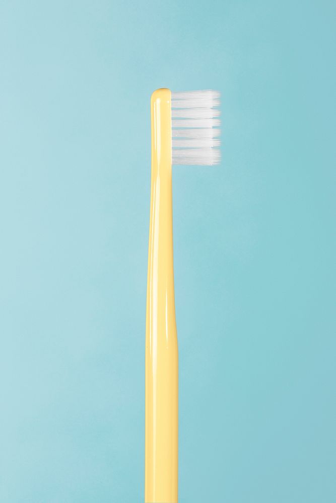 Yellow toothbrush on a blue background 