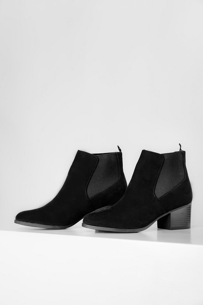 Black ankle boots on a white background