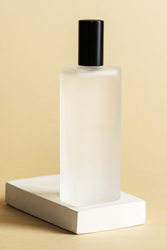 Blank perfume glass bottle on a white stone