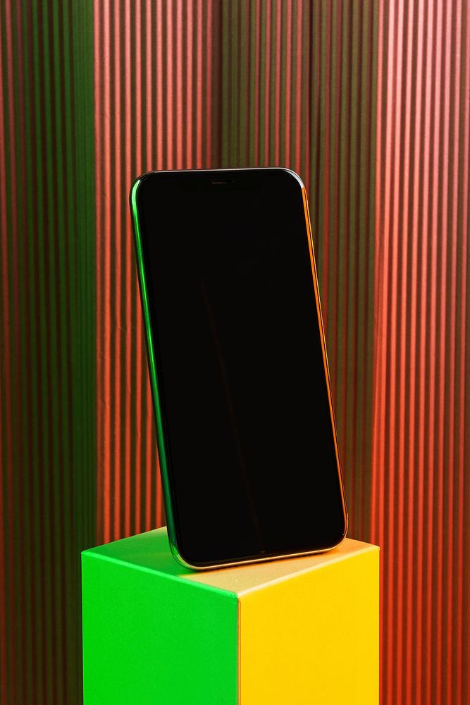 Black smartphone on neon cubic stand
