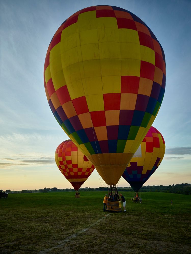 As dusk approaches, balloons land at the National Balloon Classic, a hot air balloon exhibition in Indianola, Iowa, a town…
