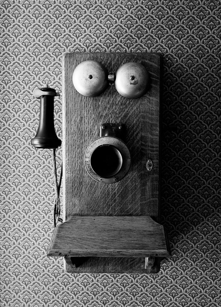 An old-style crank telepone inside a prairie "I house," part of the Ackley Heritage Center. Original image from Carol M.…