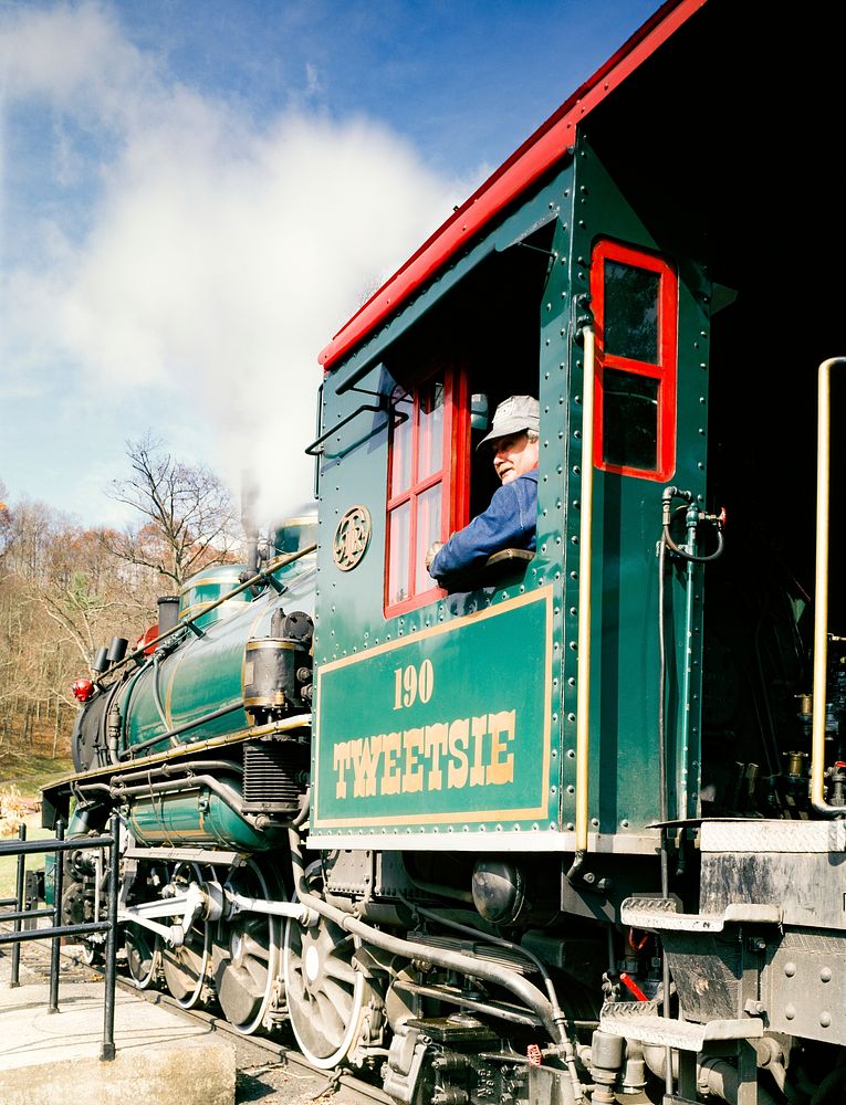 Engine and engineer of a Tweetsie Railroad steam-fired locomotive in North Carolina. Original image from Carol M.…
