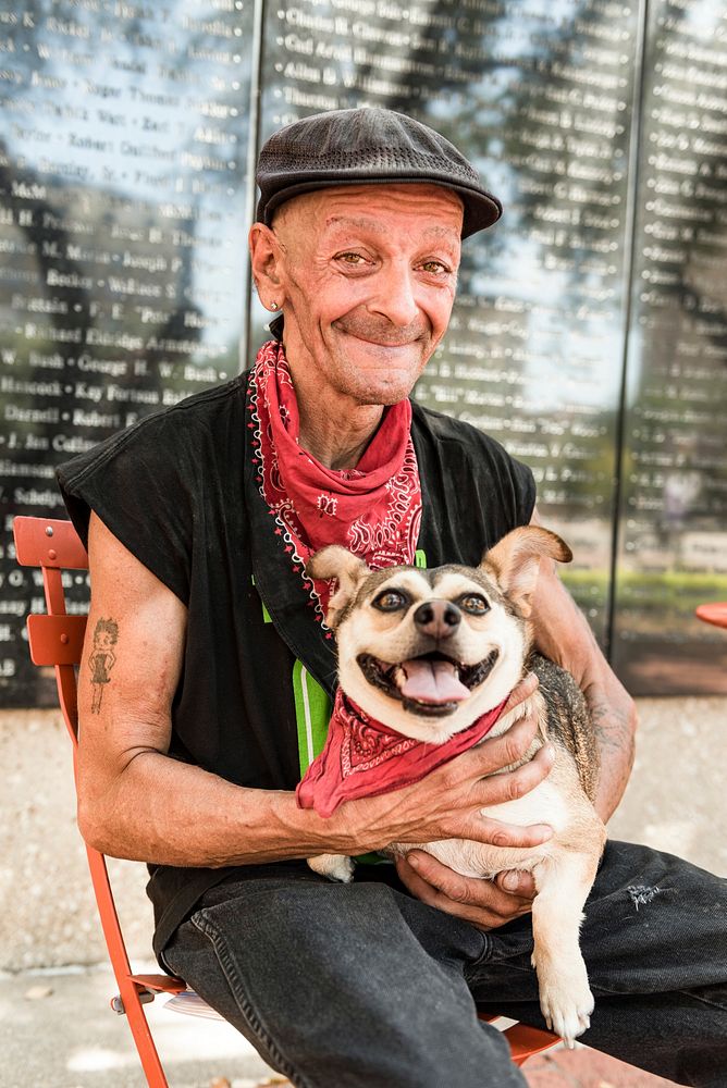 Armed service veteran Frank Smith sitting with his dog atthe streets of Dallas, Texas. Original image from Carol M.…