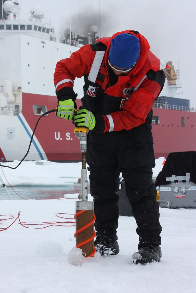 Benny Hopson from the Barrow Arctic Science Consortium in Alaska drills a core sample from sea ice in the Chukchi Sea on…