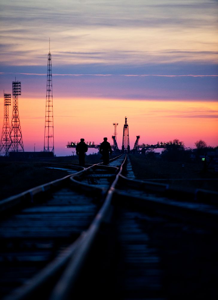 Russian security officers walk along the railroad tracks out to the launch pad Monday, Nov. 11, 2011 at the Baikonur…