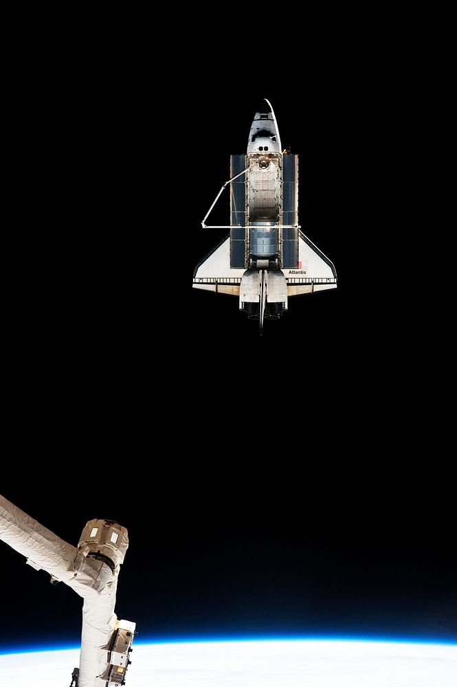 STS-135 Shuttle Atlantis leaving the ISS, 19 July 2011. Original from NASA. Digitally enhanced by rawpixel.