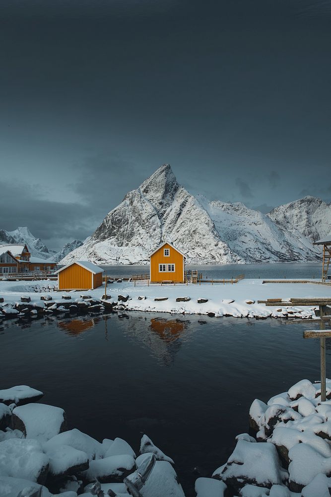 Yellow cabins by a snow lakeside