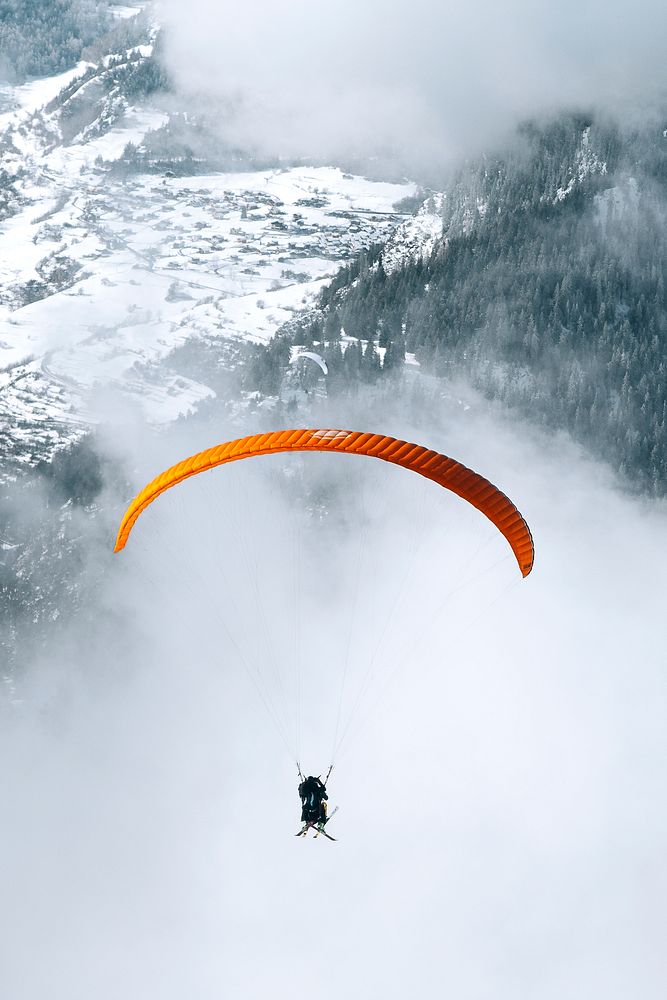 Paragliding on a cloudy day through the mountain