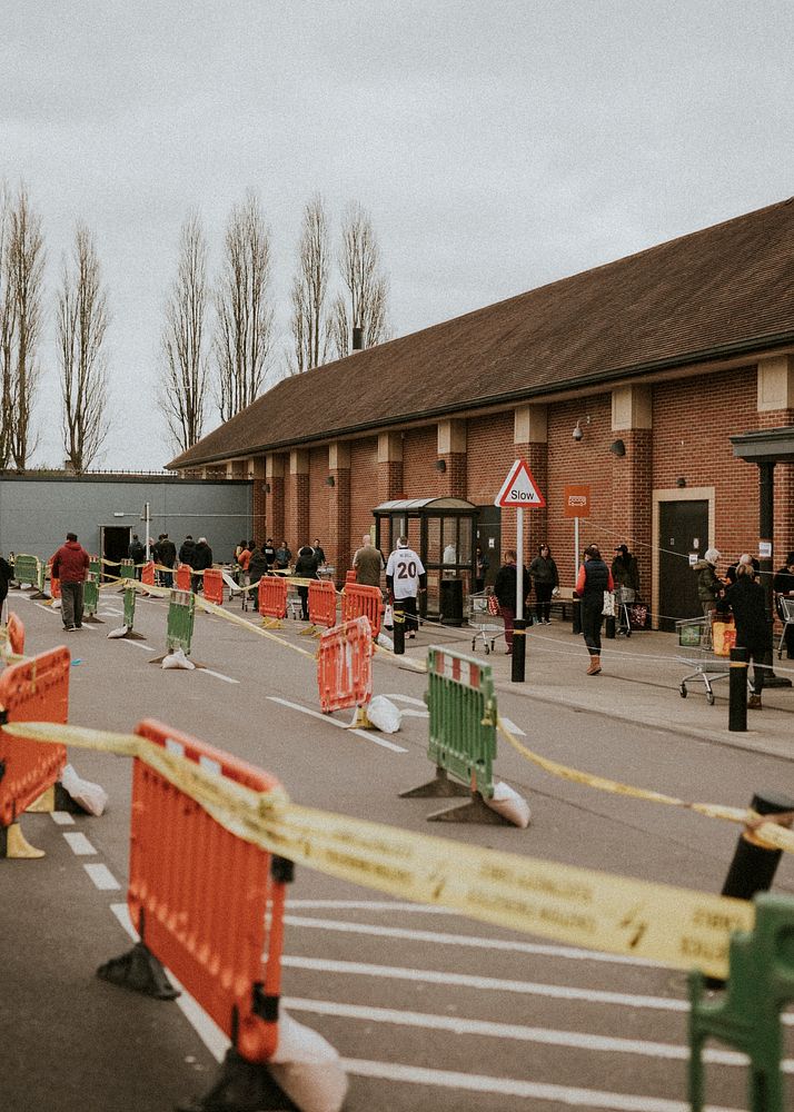 People lining up outside the supermarket with social distancing during coronavirus pandemic. BRISTOL, UK, March 30, 2020