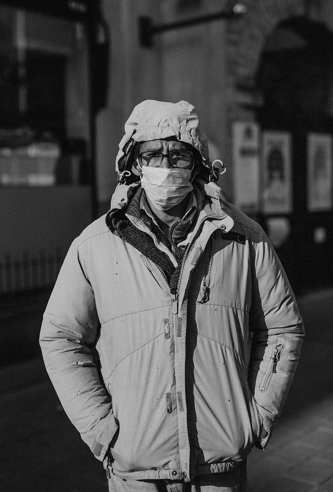 Man wearing a face mask while walking in the city during coronavirus pandemic. BRISTOL, UK, March 30, 2020