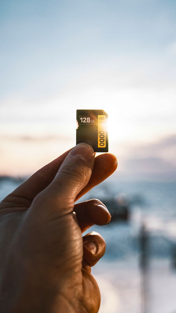 Hand holding a memory card against the sunlight