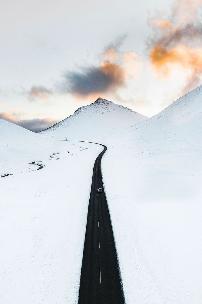 Long black road in the white winter landscape
