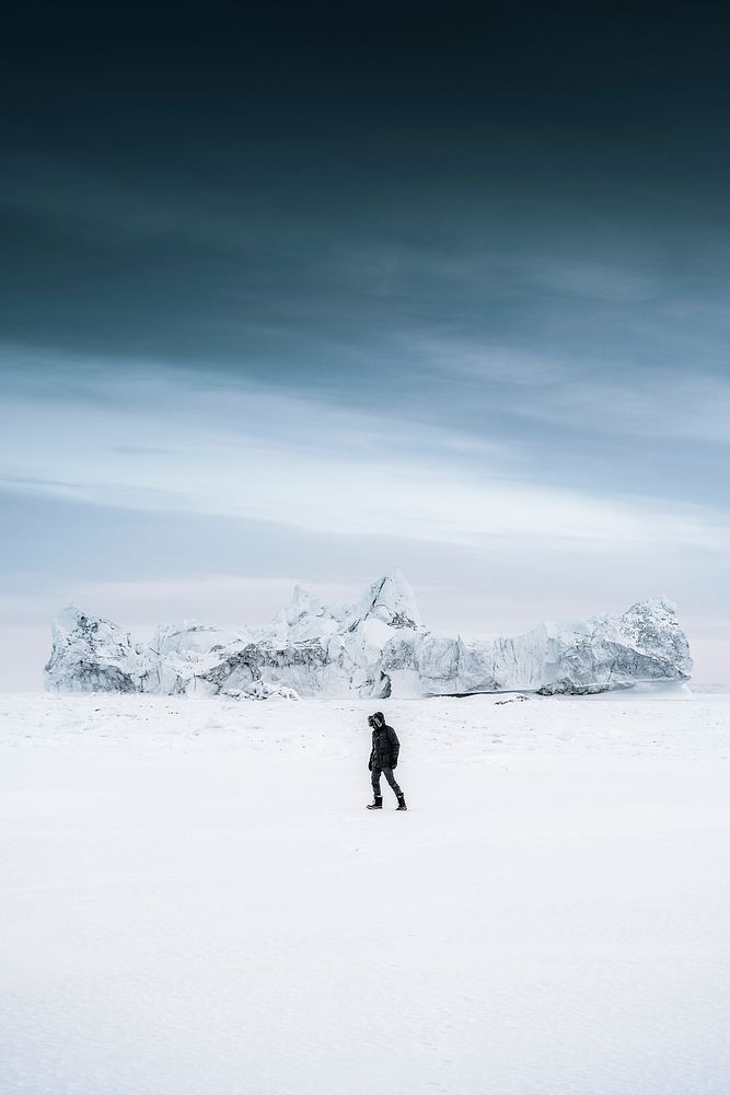 Man walking through the snow at Ilulissat, Greenland