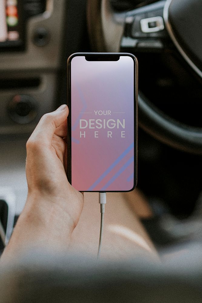 Blank smartphone screen mockup charging in a car