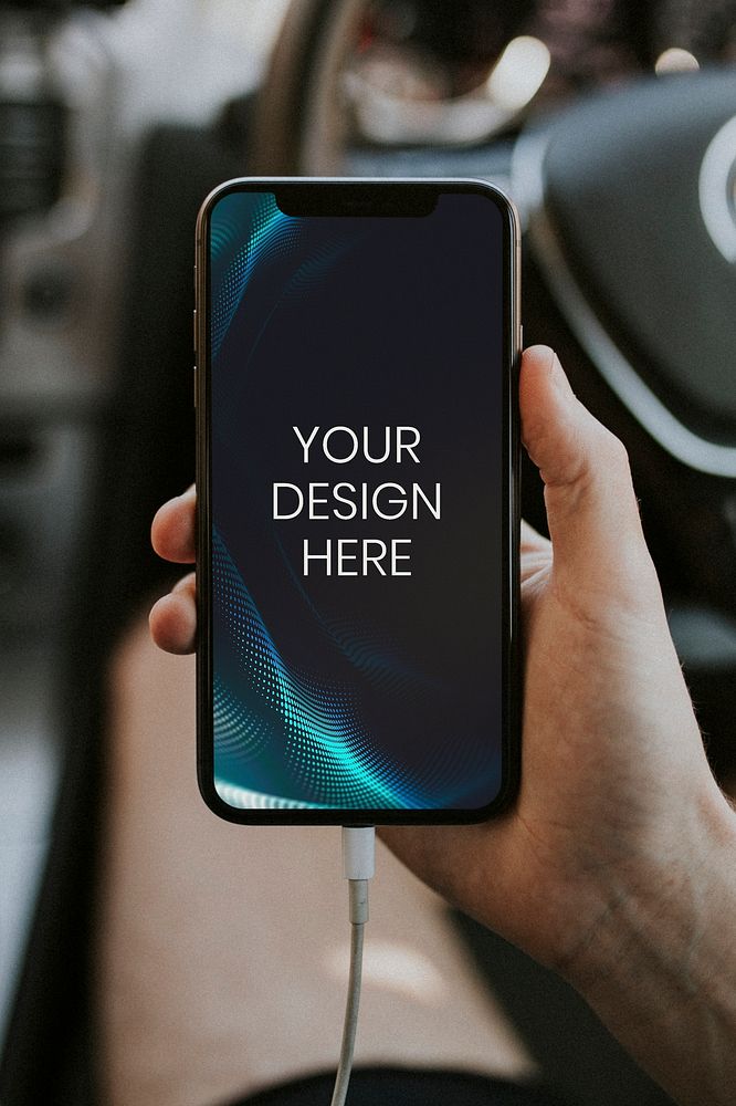 Hand holding a smartphone in a car mockup