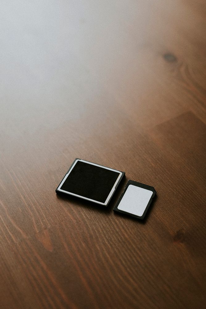 Micro SD cards and card adapter on wooden background