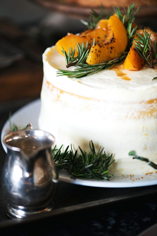Sliced apricots on top of a white cake
