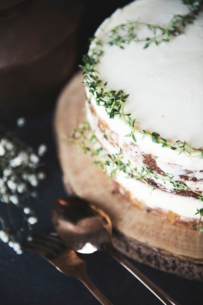 Buttercream cake decorated with thyme