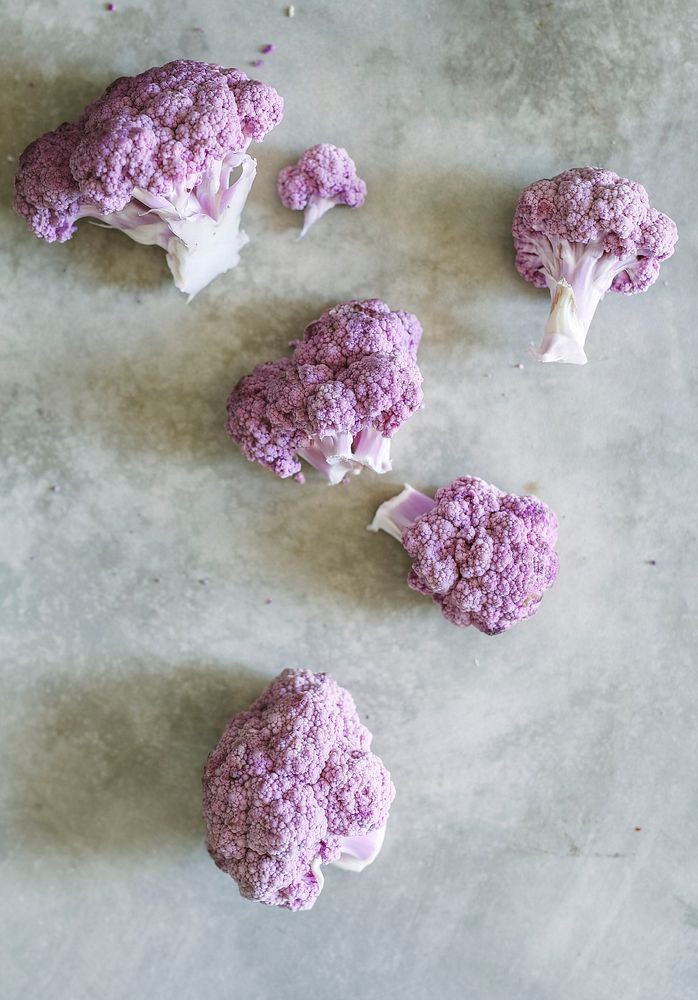 Organic purple cauliflower on a concrete surface