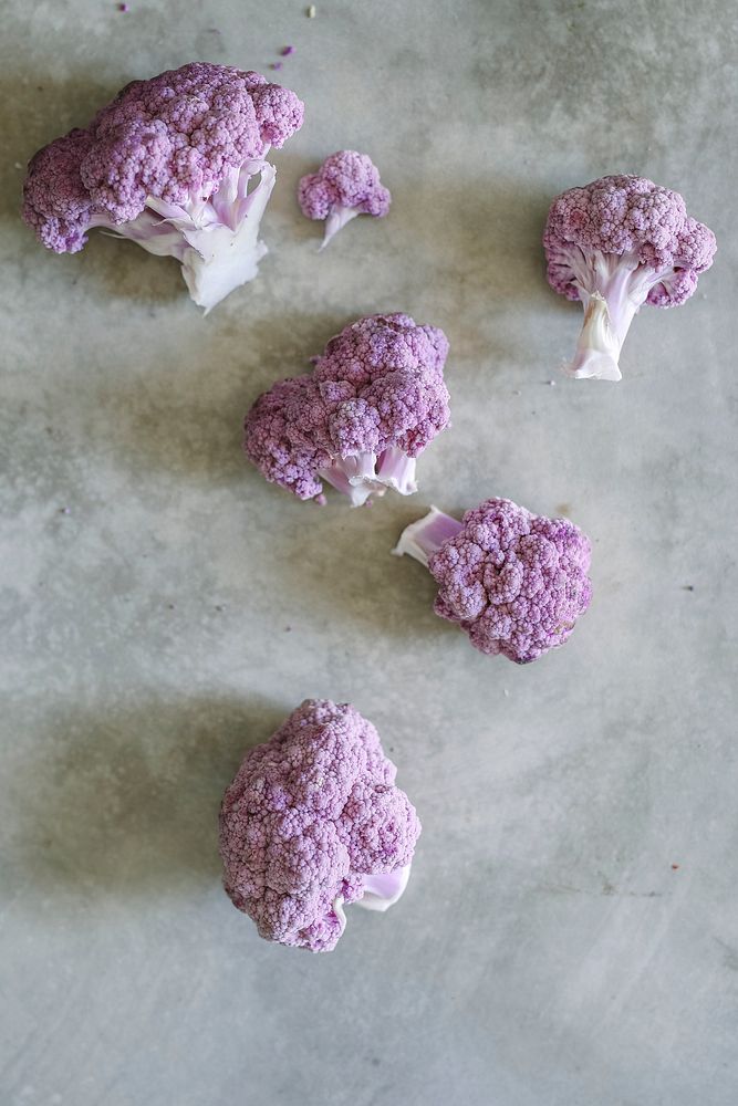 Organic purple cauliflower on a concrete surface