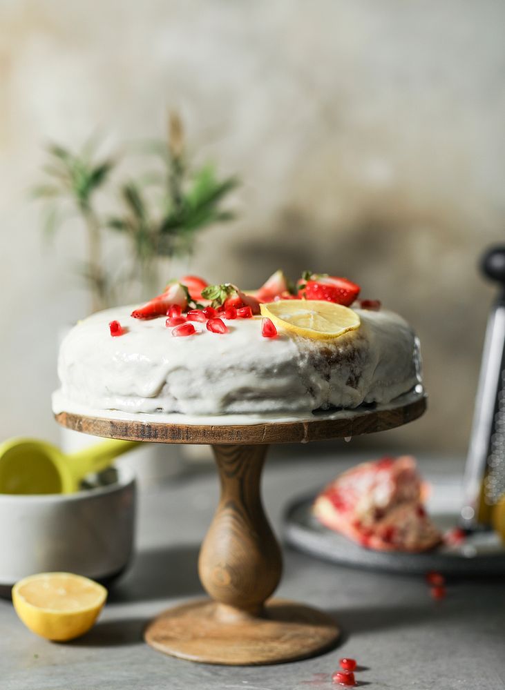 Lemon cake with fresh strawberries and pomegranate seeds