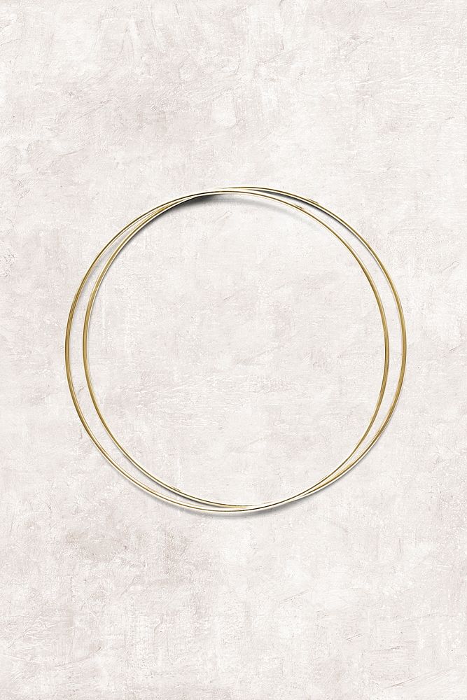 Round gold frame on beige marble background